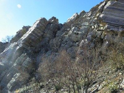 Jake trailing lion across cliff face.JPG